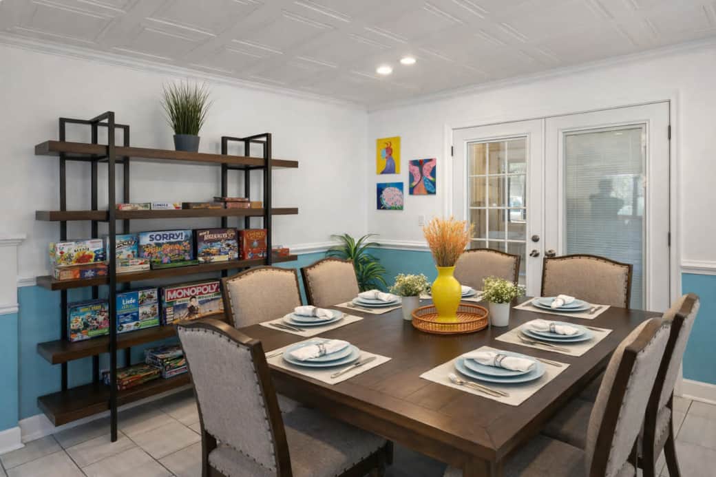 Large dining table with games and plenty of seating for meals, laughs, and making memories together.
