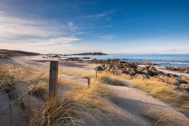 Sand, marram grass and rocky shoreline at the North End beach on Iona
