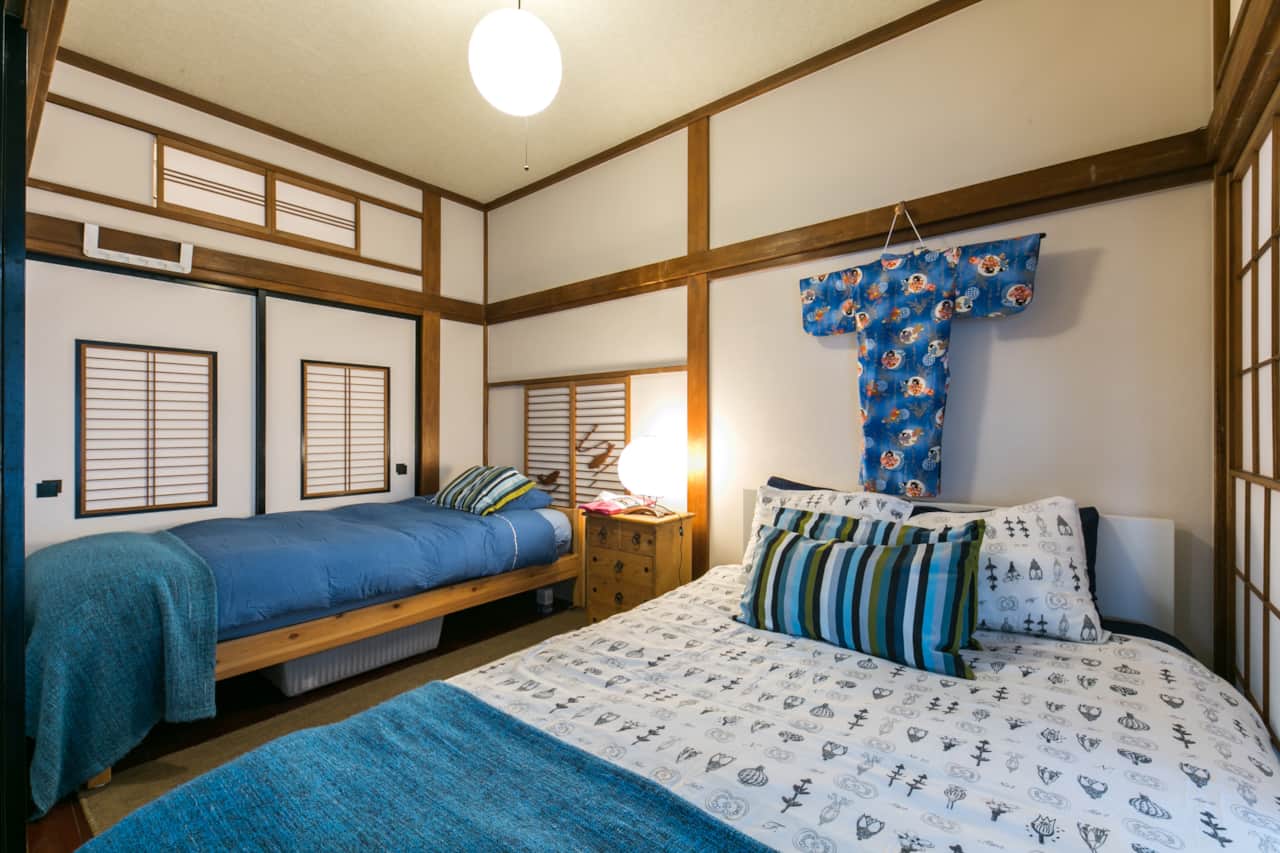 Stylish bedroom with twin bedding and traditional kimono art