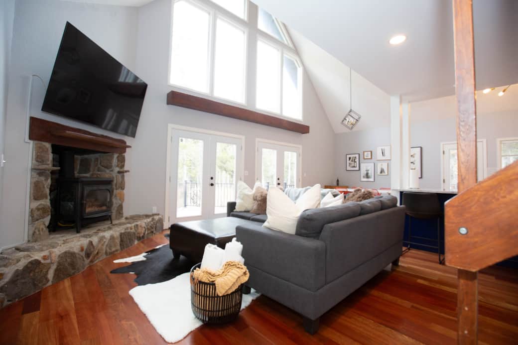 Comfy, cozy hygge living room with 72" TV, plush pillows and throws and bright light Comfy, cozy hygge living room with 72" TV, plush pillows and throws and bright light
