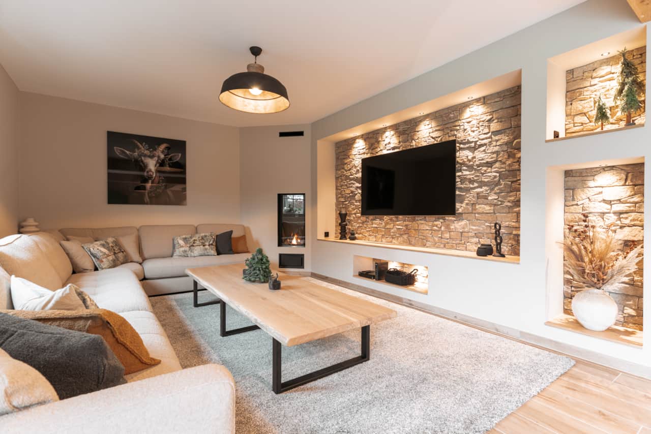 Cosy living room with television and stone feature wall
