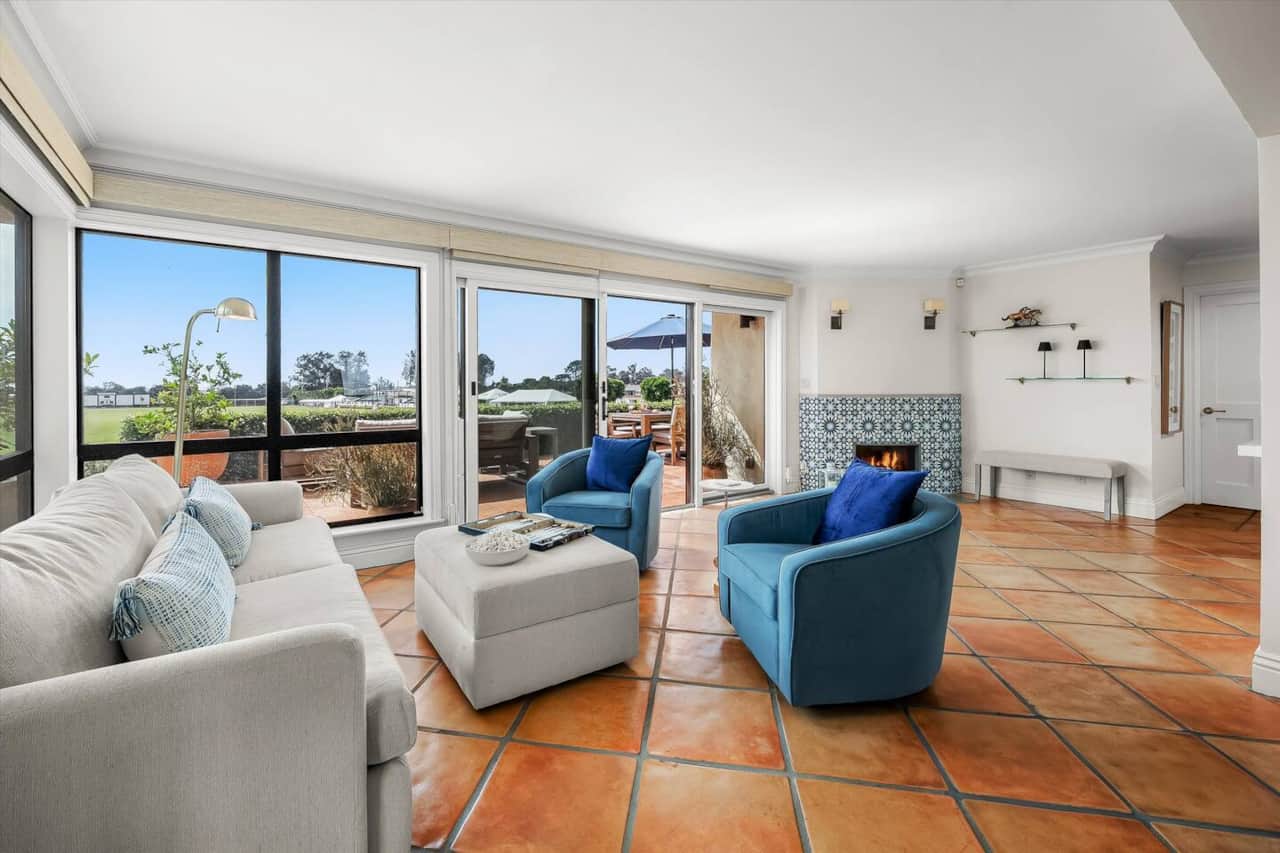 Sunlight and polo-field views fill the living room