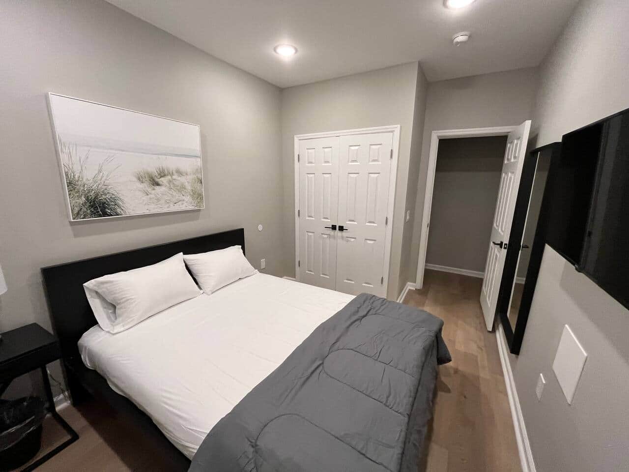 Bedroom 1 with queen bed flat screen tv and closet.