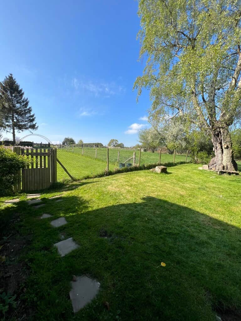 Looking from the living room doors across the garden onto the farm fields
