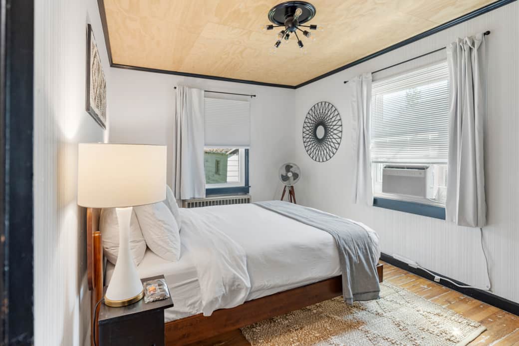 A queen bed with luxury linens, vintage touches, and blackout shades for the perfect nights rest.