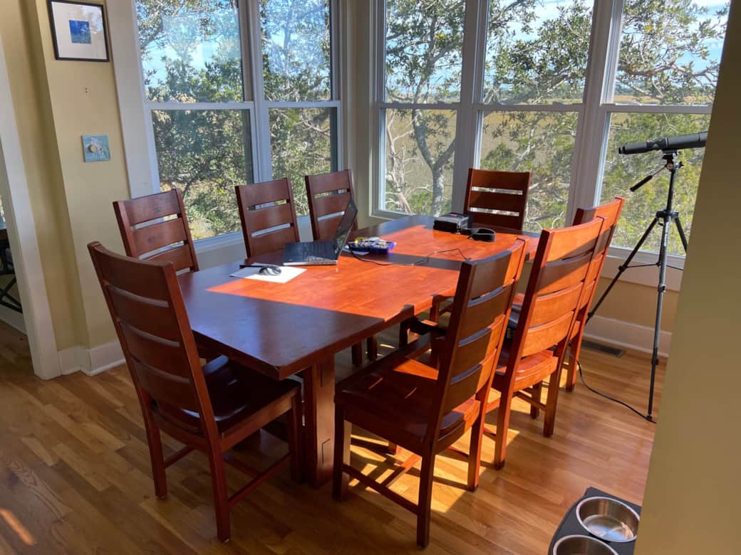 Dining area surrounded by windows and views. Dining area surrounded by windows and views.