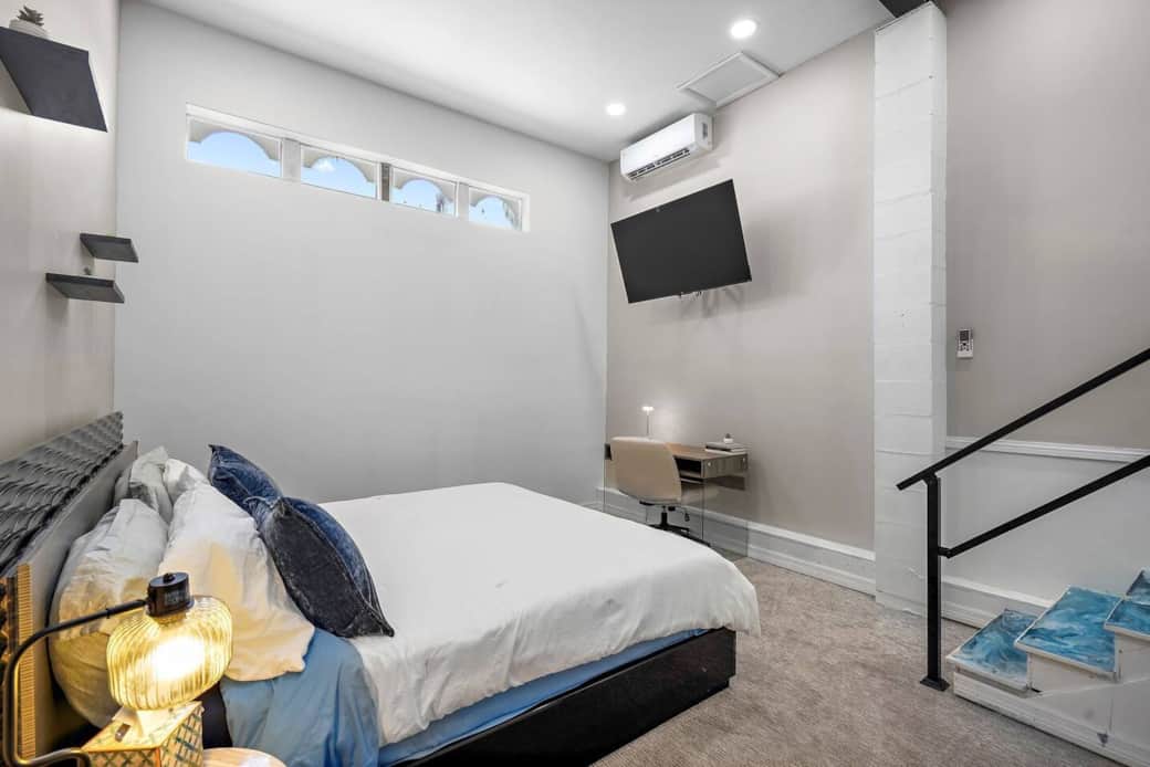 Bedroom with King bed, dresser, Smart TV and work station