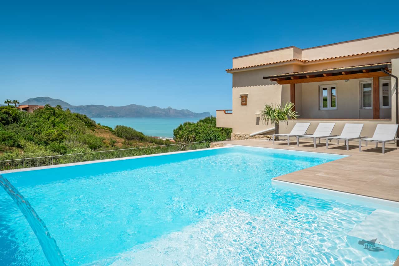 Relax by the stunning infinity pool with cascading water features, offering breathtaking sea views.