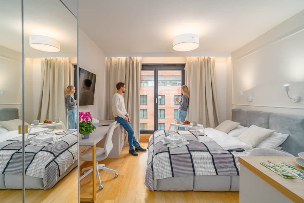 A bright and cozy bedroom with a large double bed and modern décor.