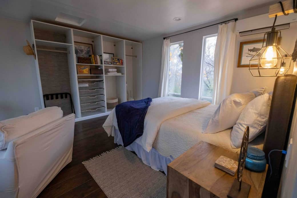 Bedroom area includes plenty of hanging space, drawers and luggage rack. 
