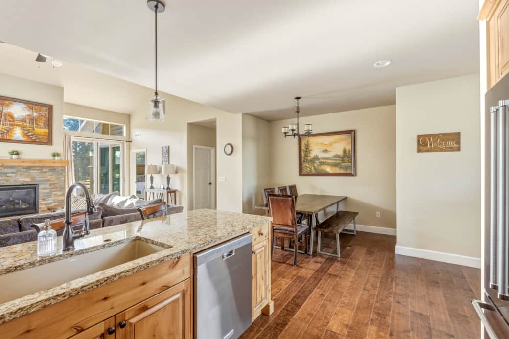 Kitchen peninsula with granite counters, undermount sink, and bar seating for three.