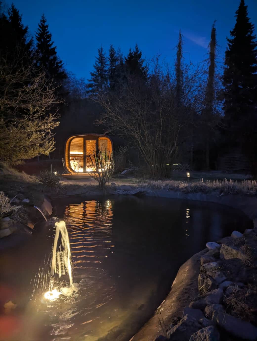 Sauna und Gartenteich bei Nacht