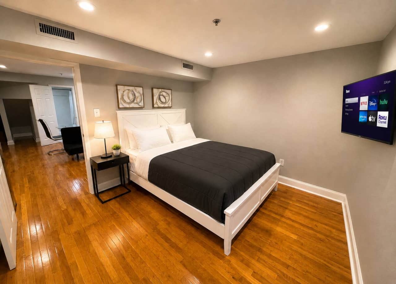 bedroom with queen, bed, flatscreen TV ,window and a large closet.