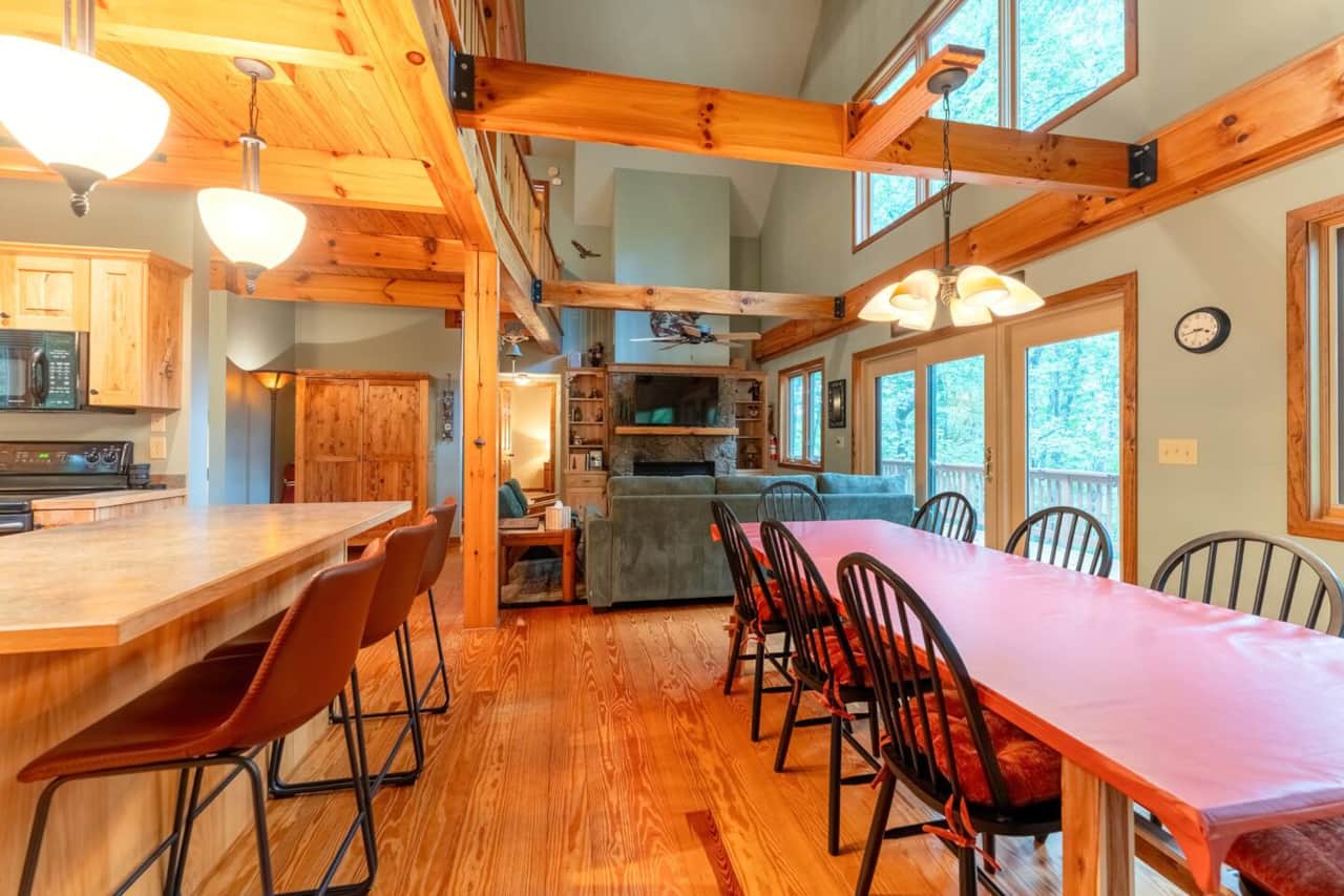 Open-concept great room — cook, eat, and gather under soaring timber beams.