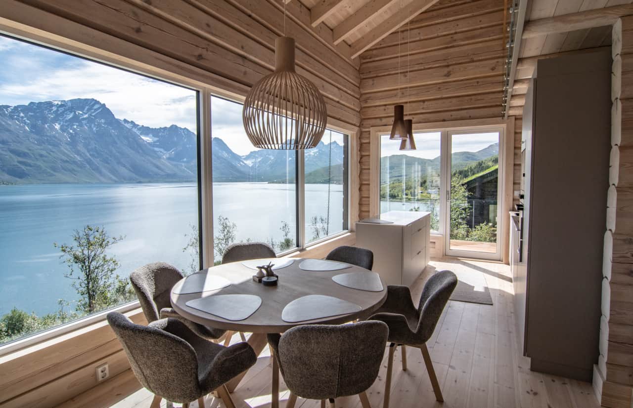 Nordlys kitchen dining area with panoramic fjord and mountain view