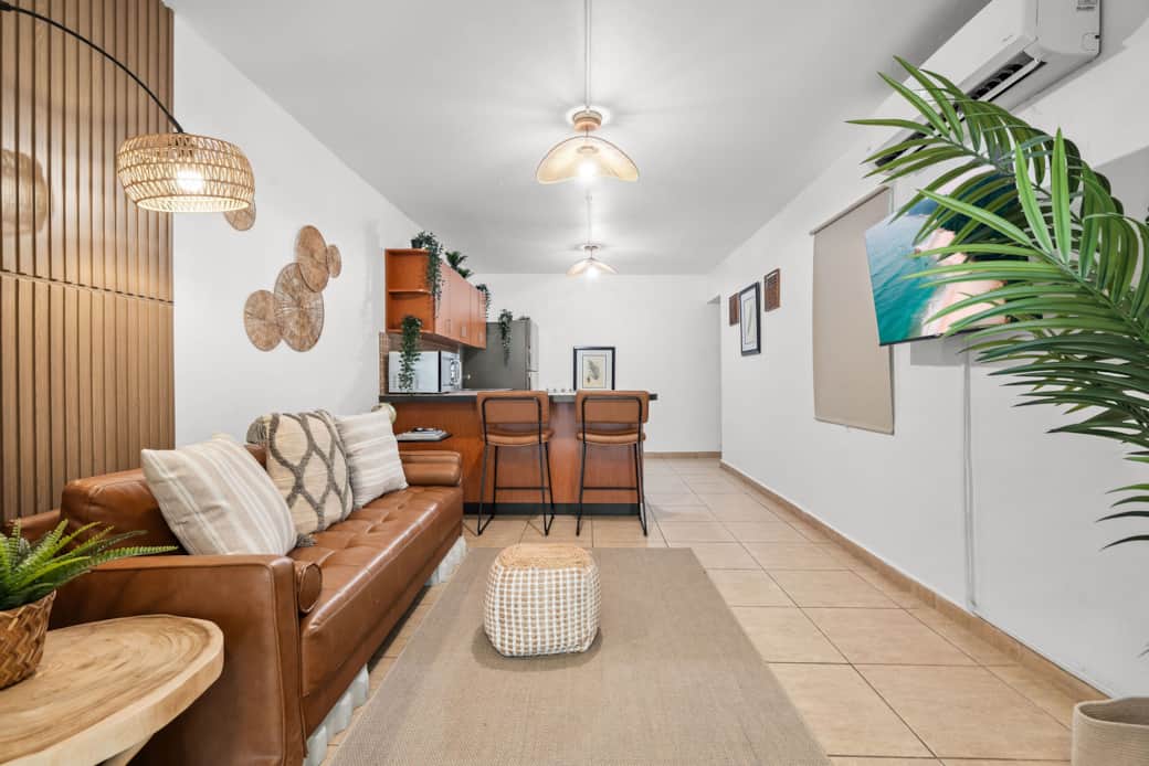 Open-concept living area with natural textures and bar seating