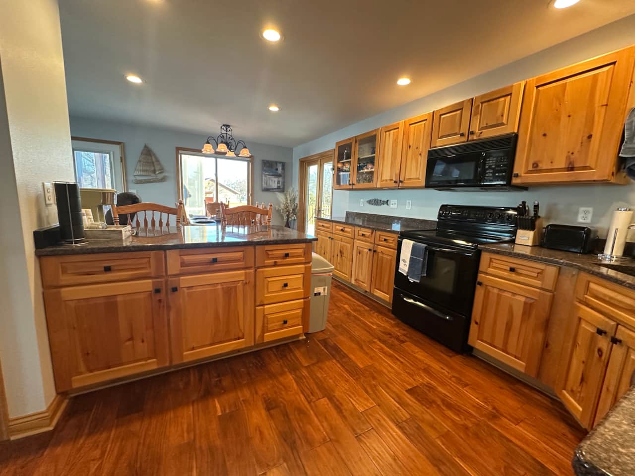Kitchen is stocked with plates, silverware, cups, a blender, crockpot, toaster and more!