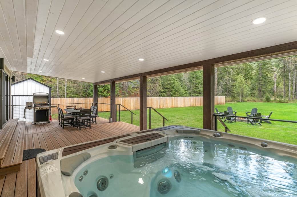 Expansive outdoor living with a covered year-round deck allows you to enjoy any season in North Idaho. A Weber Gas BBQ, Pollywood Dining Table, Hot Tub, hooks for your BIG Hot Tub towels, and a Fiberon deck to support all the fun you'll have. Enjoy!