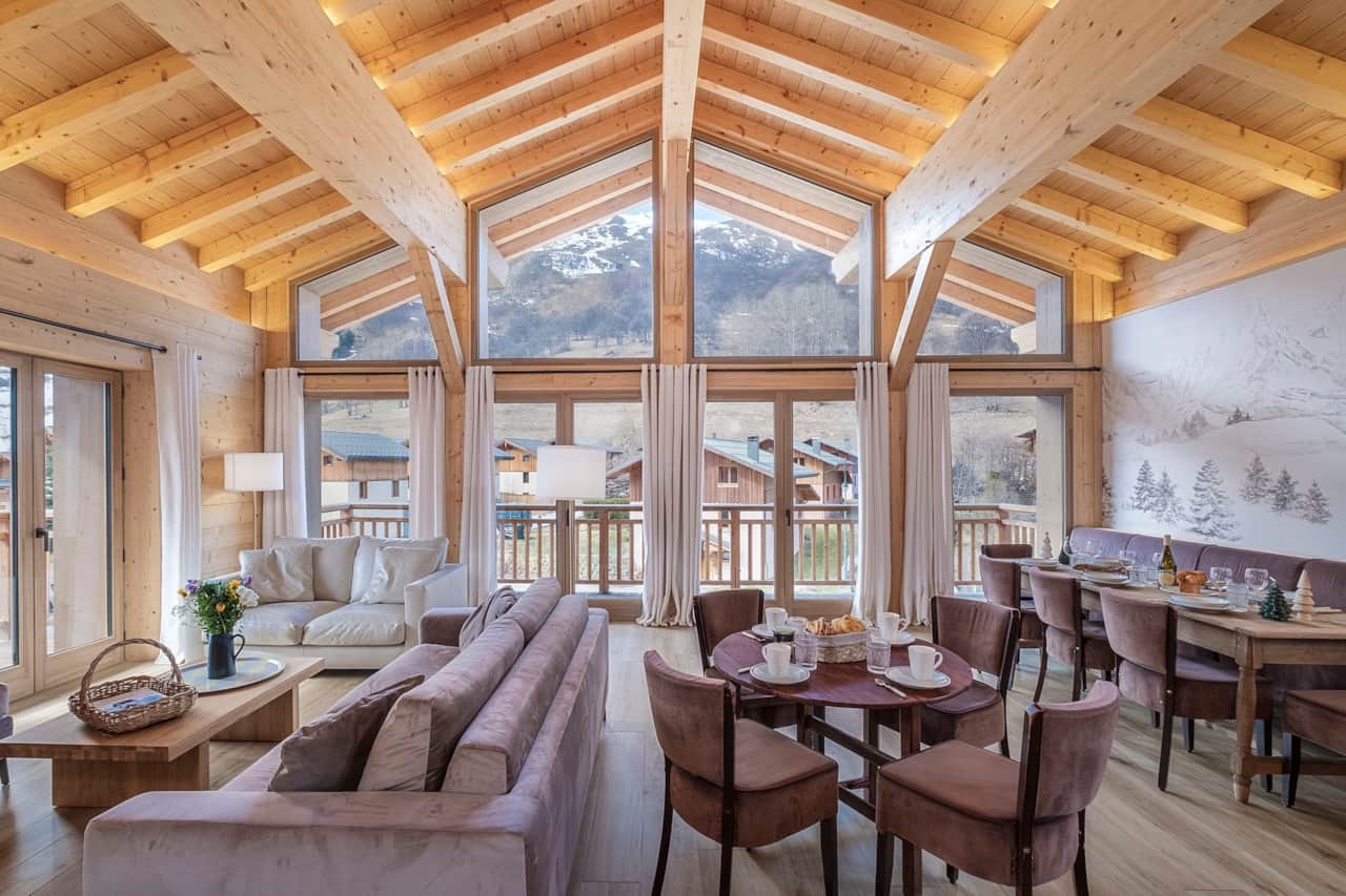 Large, bright living room with exposed beams and a warm dining area.