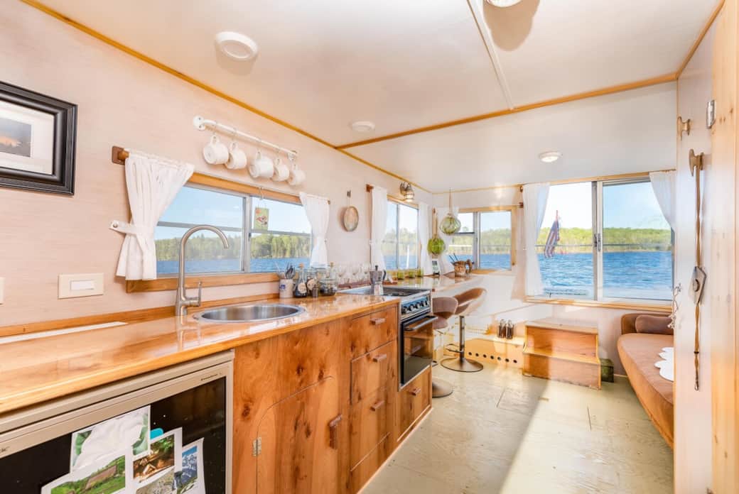 Fully equipped galley kitchen with gas stove, fridge + small freezer, and service for four Fully equipped galley kitchen with gas stove, fridge + small freezer, and service for four