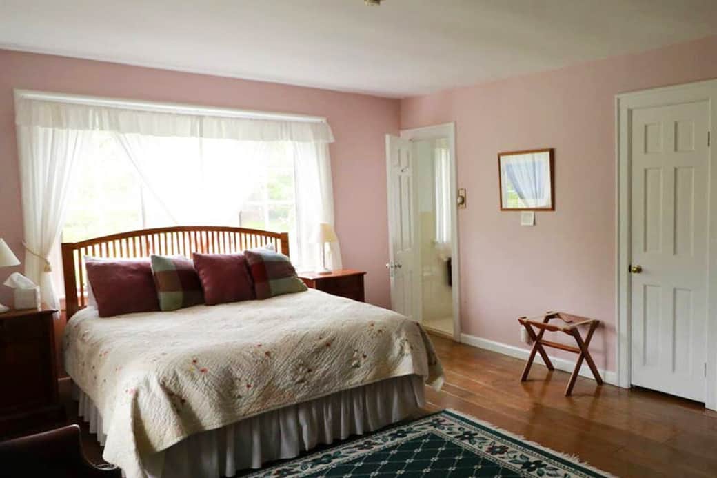 The Lavender Room features a queen-size bed, a private bathroom and a fireplace to warm you on cool evenings. It is upstairs off the balcony overlooking the Great Room, on the southeast side of the house with views of the mountains and valley.