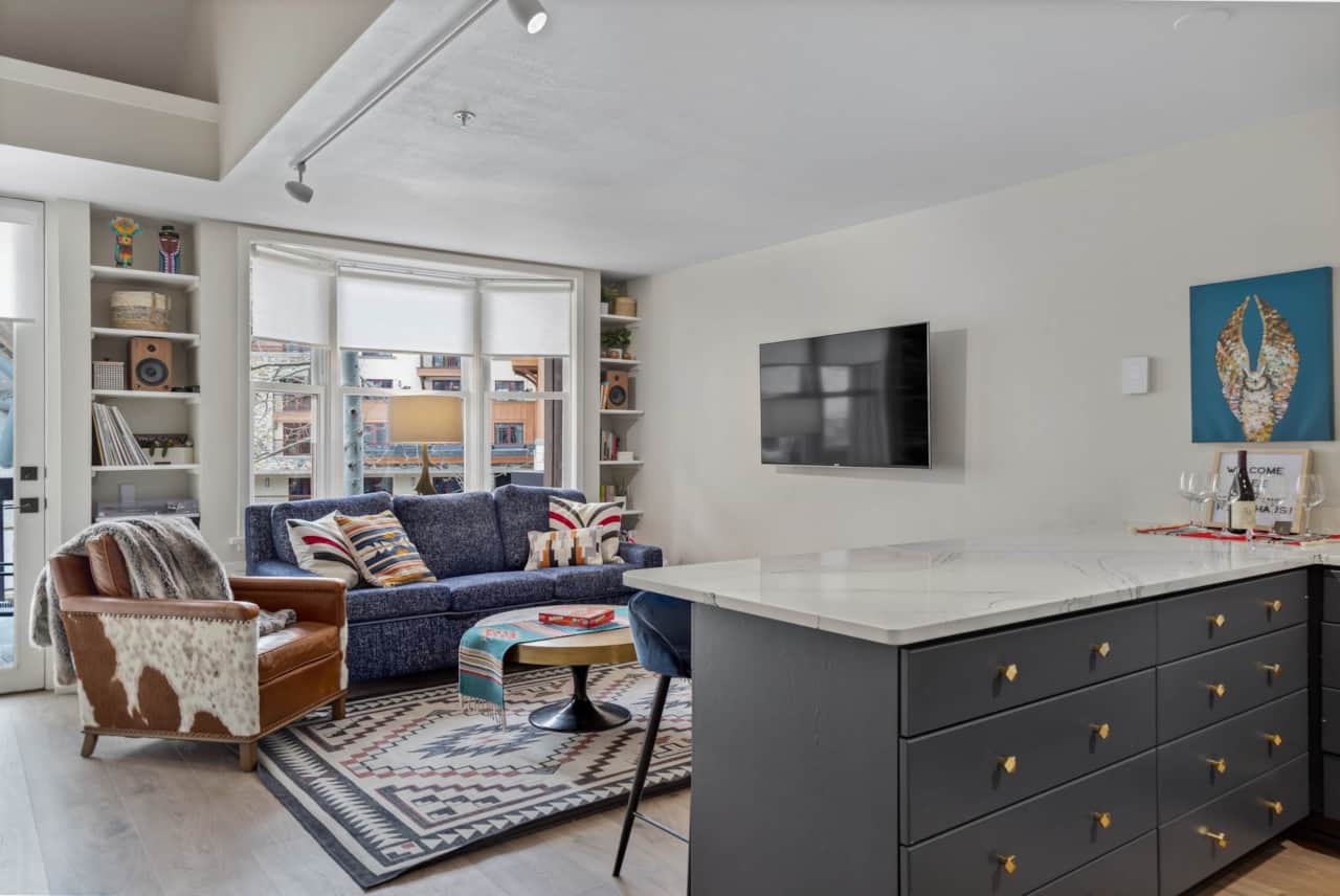 Bay windows and a private patio overlooking the plaza below