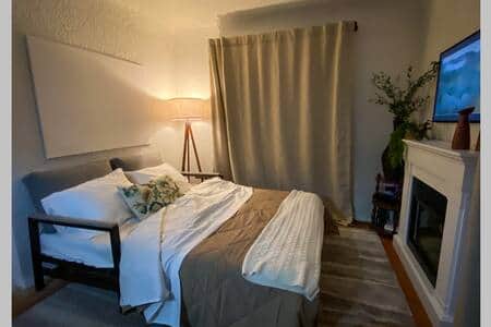 Sofa converts into a queen bed. Bed sheets, blankets and pillows are located in the bedroom closet.