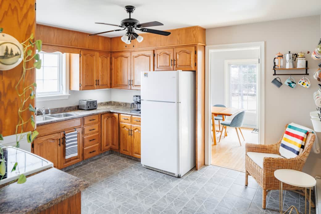 Bright, fully equipped kitchen with ample counter space and natural light.