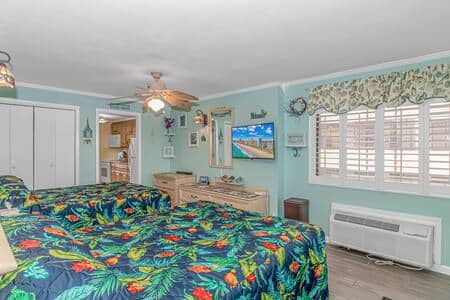 Master bedroom featuring 2 Comfy Queen size beds, ceiling fan and flatscreen TV!