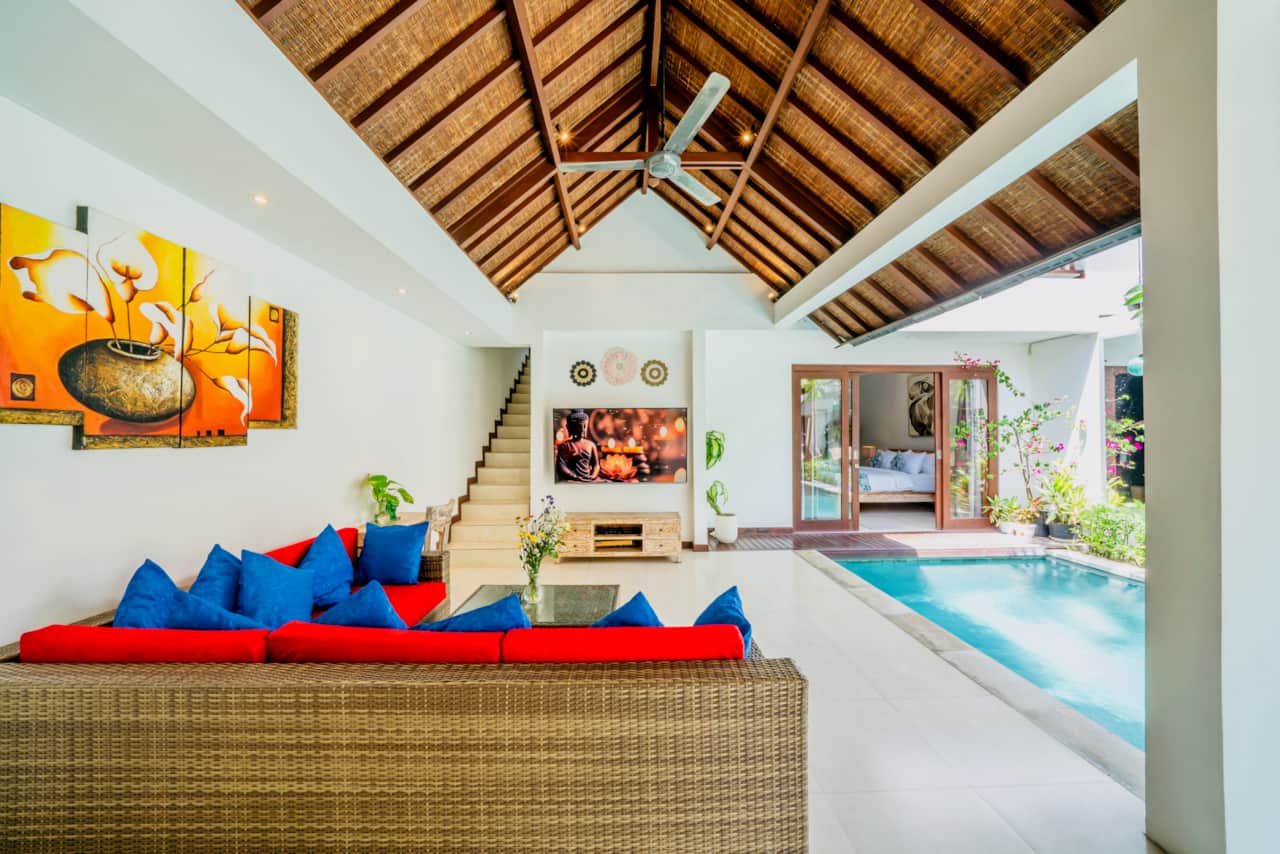 Open living area with pool access and tropical design