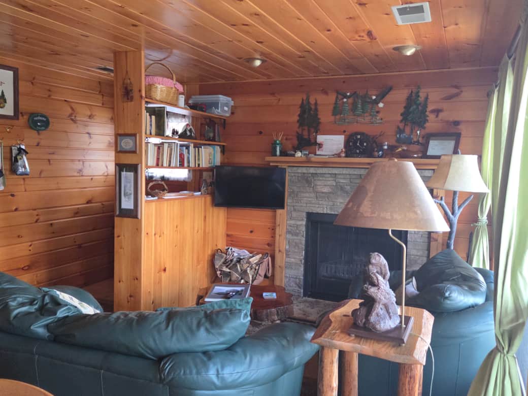 The great room features a wood burning fireplace and a TV perfect for streaming favorite shows