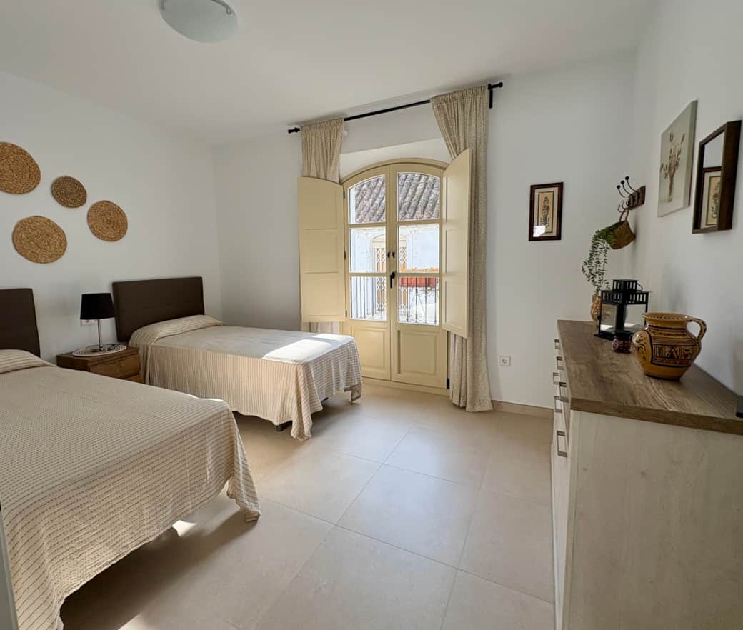Schlafzimmer mit Balkon und Einzelbetten