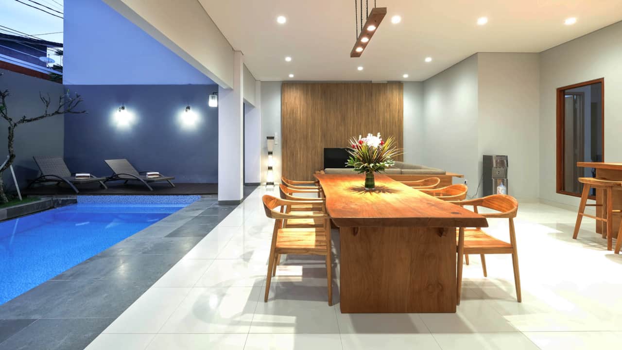 Dining area with clean modern layout by the private pool. Perfect for special dining in experience 