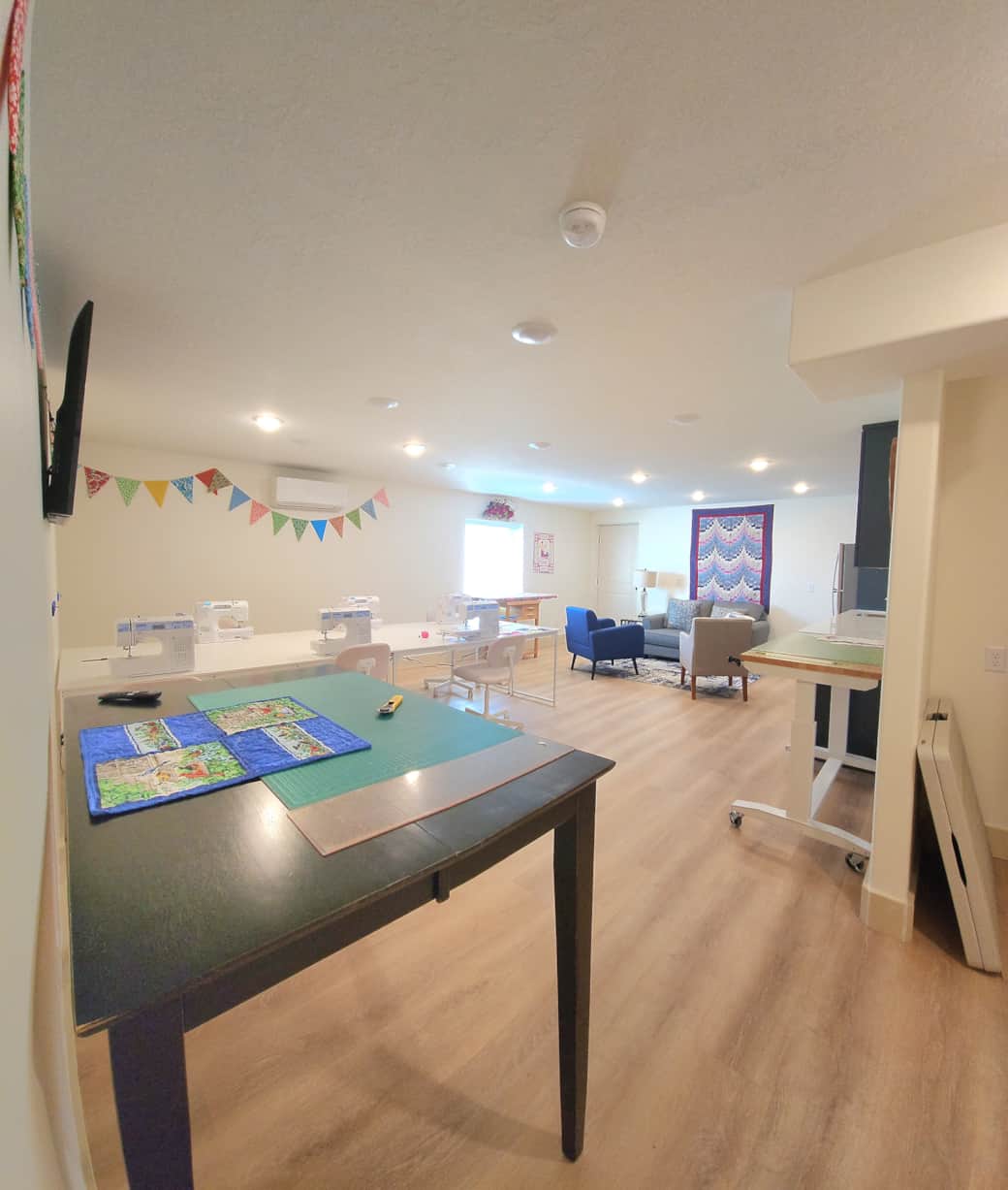 Sewing studio for six has two cutting tables, two ironing stations, and comfortable sewing chairs. Sewing studio for six has two cutting tables, two ironing stations, and comfortable sewing chairs.