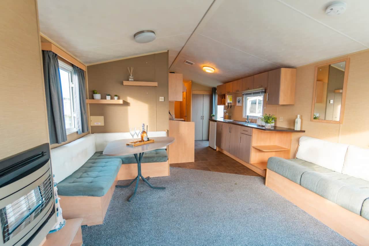 Open-plan lounge, dining area and kitchen in the three-bedroom caravan.