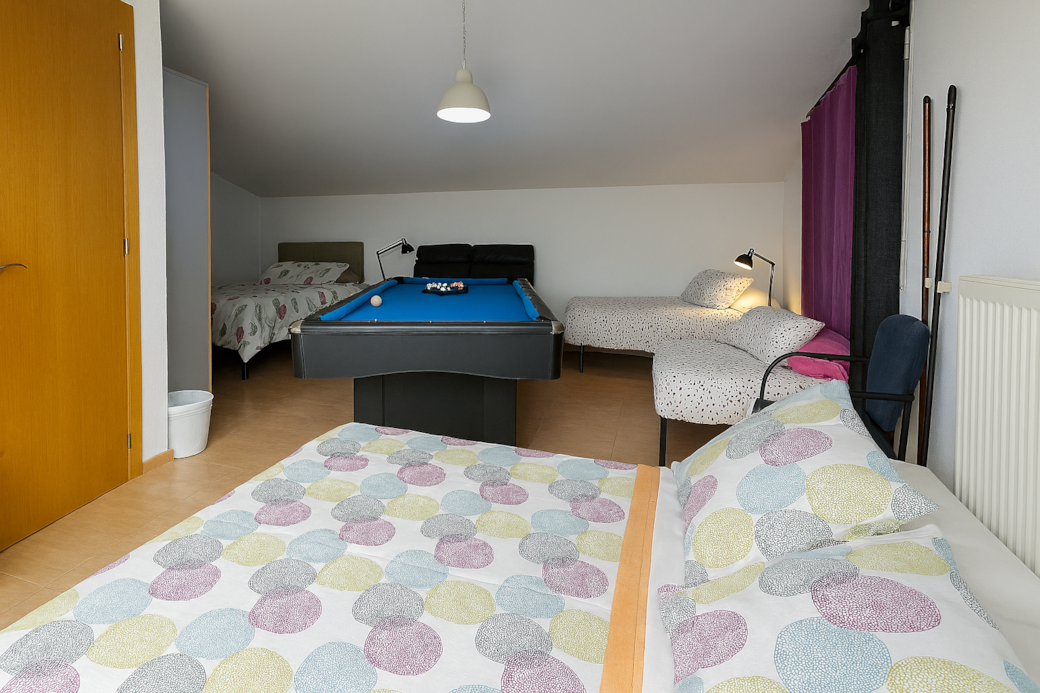 King bed, double bed, and two single beds. Large TV, wardrobe, and bedside table. Sleeps up to 6!