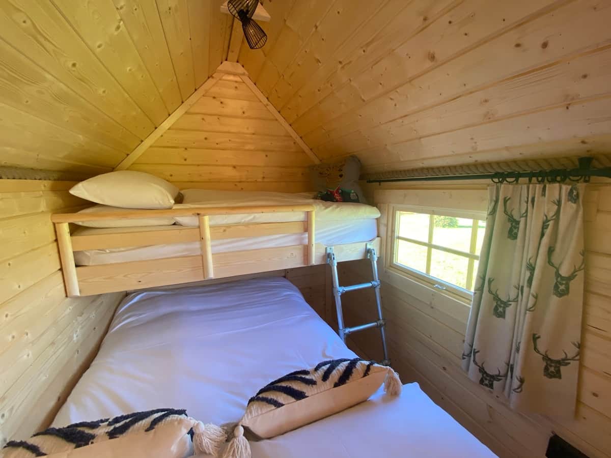 Separate bedroom off main room, with small double and small single bunk