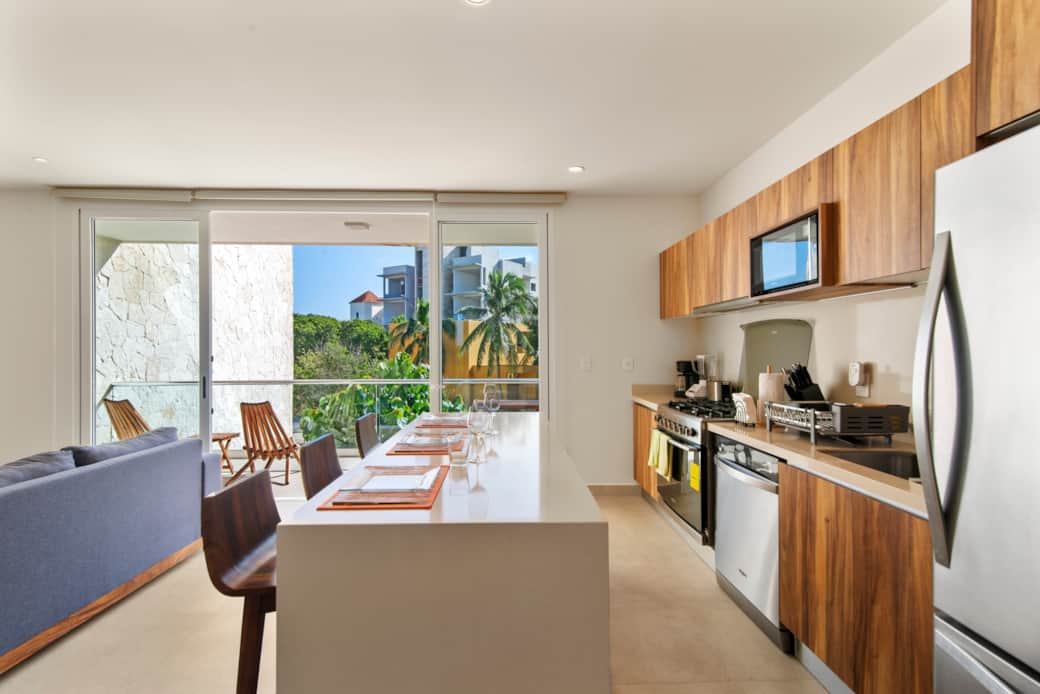 Fully equipped kitchen & dining area with balcony access.