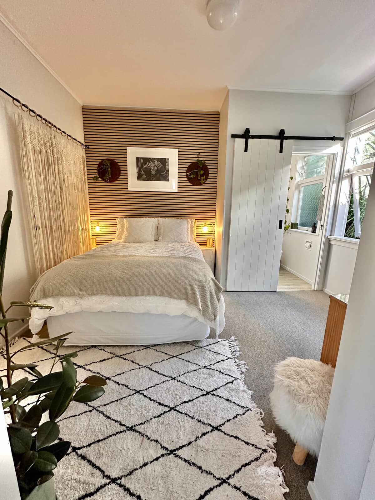 Comfortable double bed, electric blanket, Woolen underlay & quality NZ wool duvet. All bedding has fresh mattress & pillow protectors & cotton linen. Private outlook onto entrance and gardens. Small ensuite through barn door. Wardrobe for storage.