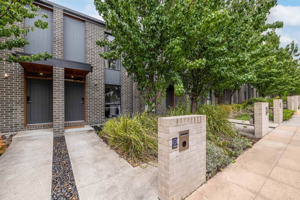 Enter a world of modern elegance as you approach the entrance, invites you into a space that's both stylish and comfortable. Lush trees and manicured shrubs line the pathway, offering a hint of the serene living experience.