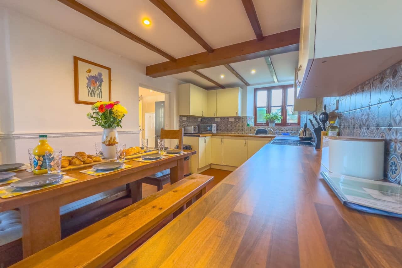Fully equipped kitchen with dining table set for breakfast with table for 10 guests