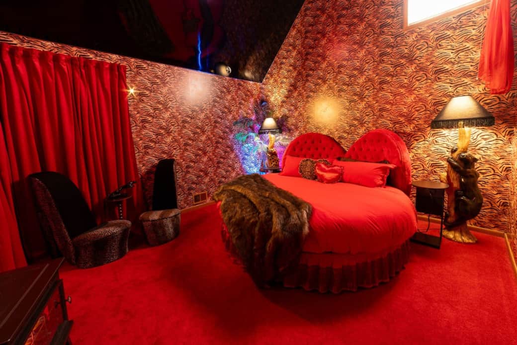 Honeymoon Suite with round bed, shoe chairs, and vintage panther lamps