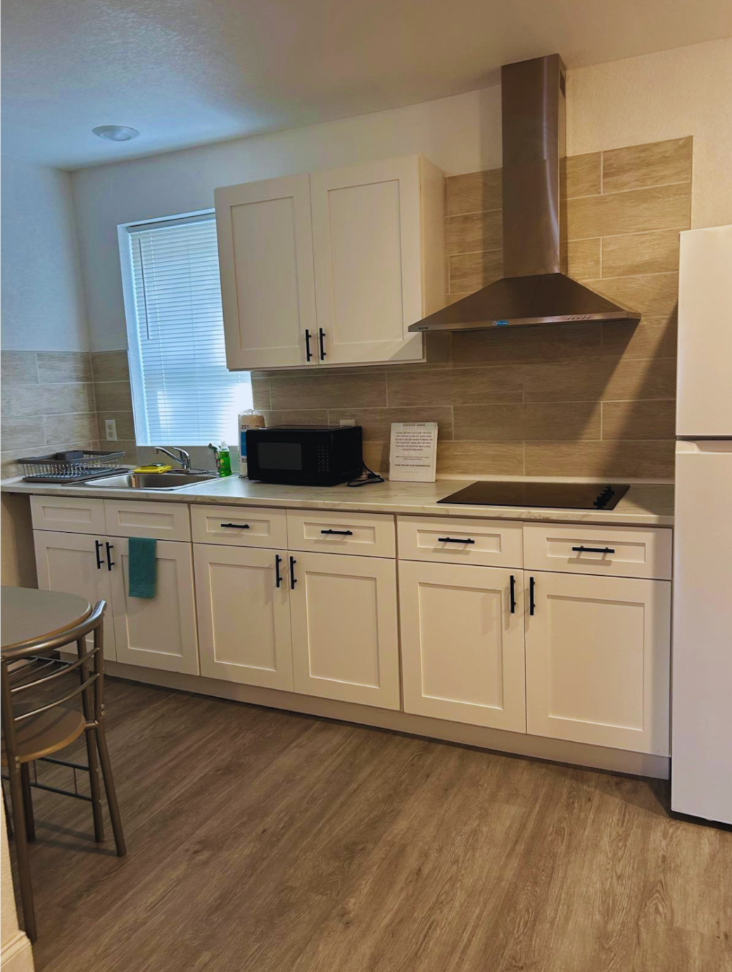 Fully equipped kitchen with coffee maker, microwave, and ample cabinet space. Lakeland, FL