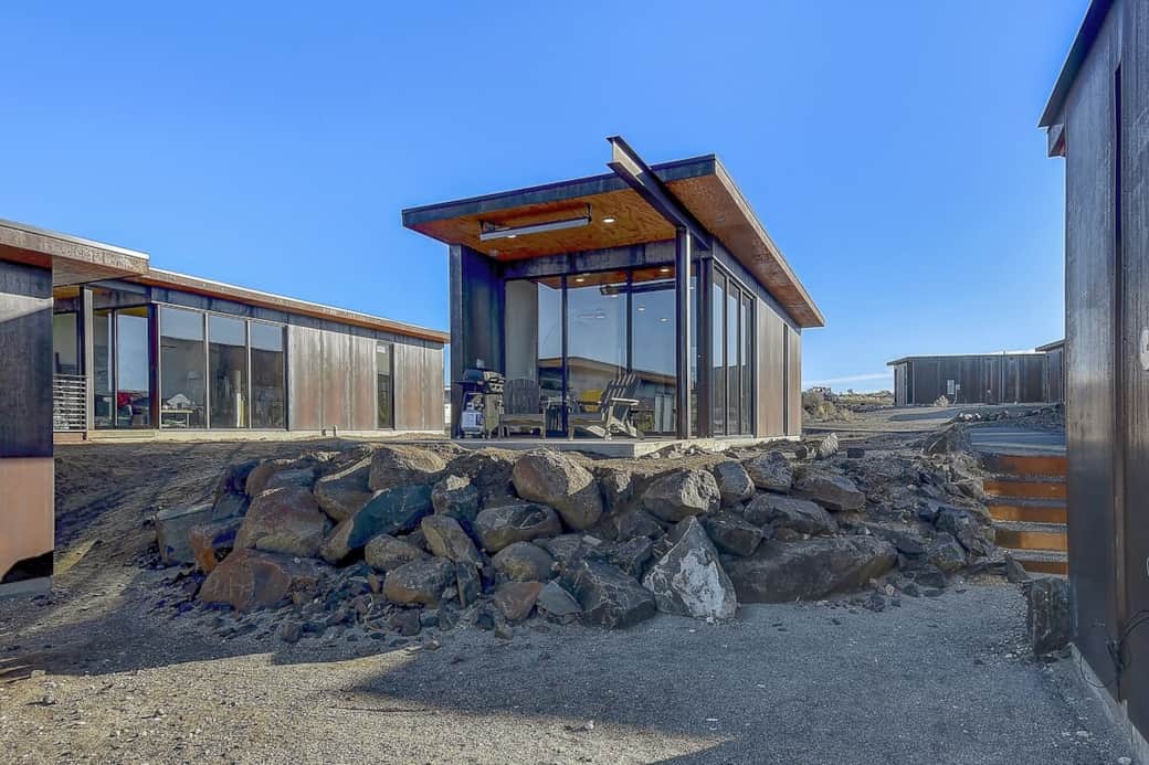 The exterior with the patio. Has grill, furniture, heater above. View of the gorge. Floor to ceiling windows. 