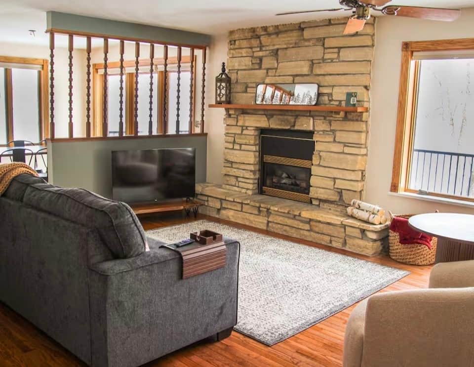 Inviting living area with stone fireplace and a 50-inch Roku TV. Inviting living area with stone fireplace and a 50-inch Roku TV.