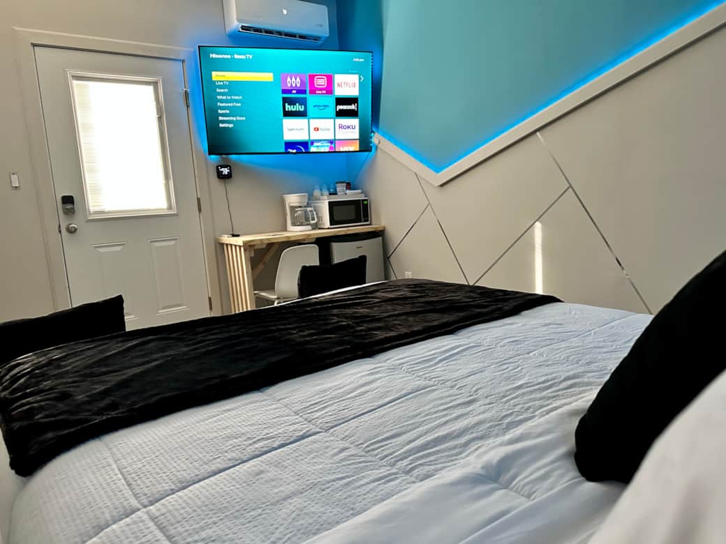 Comfortable queen bed with extra pillows and blanket