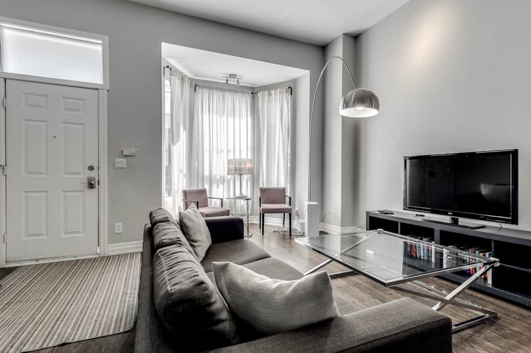 Illuminated and spacious living room in a Toronto high-end short-term rental.