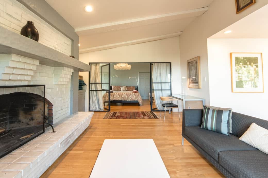 Family room with gas fireplace and glass wall to owners suite