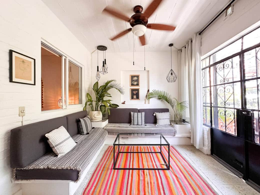 Sun-filled living space with built-in lounge seating and tropical accents — a calm, airy retreat perfect for slow mornings, reading, or unwinding after a day in Puerto Vallarta.