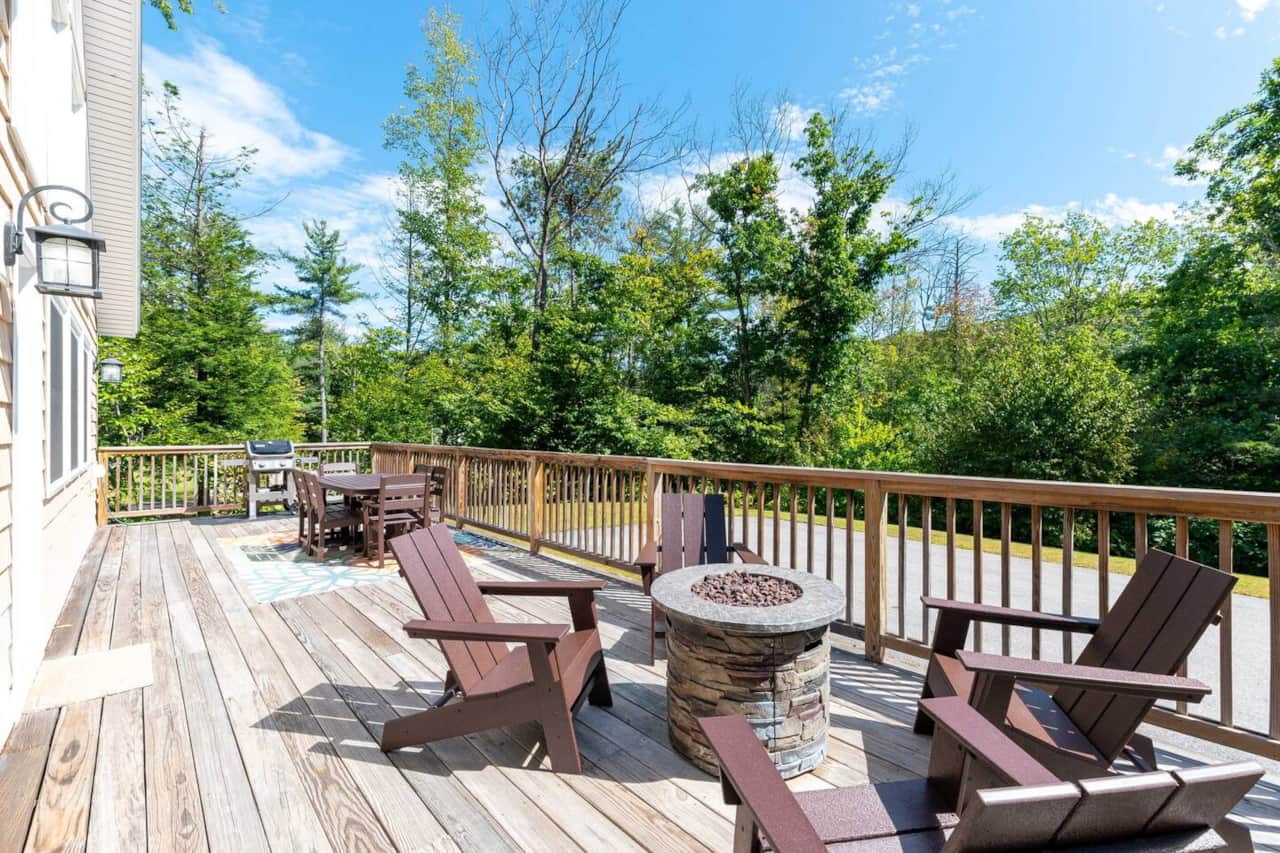Large deck with Polywood dining set and adirondack chairs